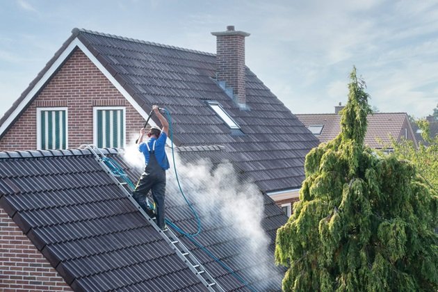 Elite Roofing Noosa professional team performing roof cleaning on a residential property